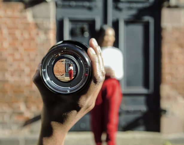 Person Holding Black Metal Zoom Lens